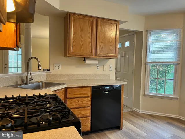 a kitchen with a sink and a stove top oven