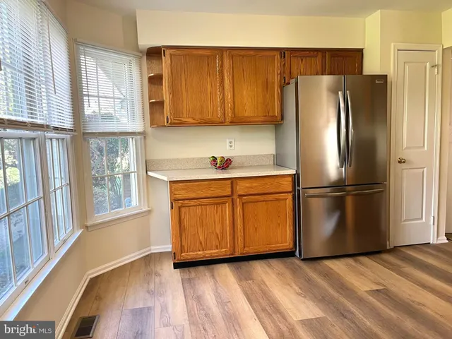 a kitchen with stainless steel appliances granite countertop a refrigerator and a sink