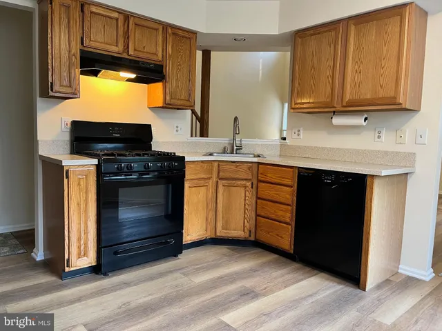 a kitchen with stainless steel appliances a stove a sink and a microwave