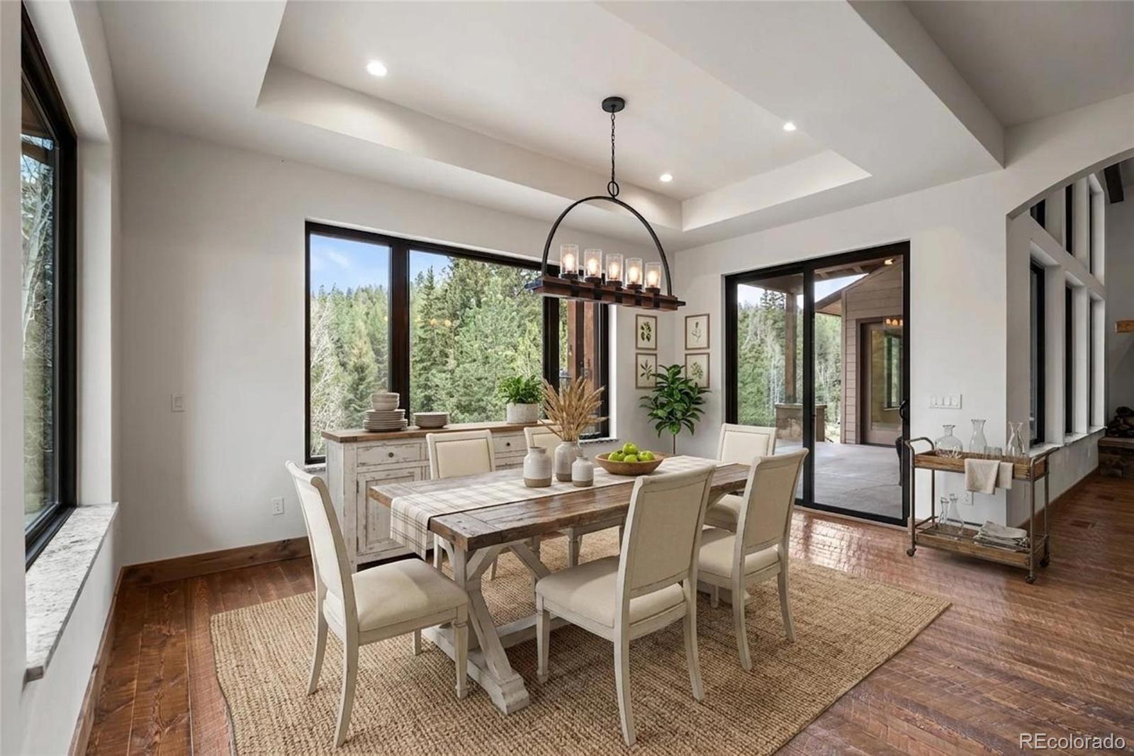 280 Double Tree Road Bailey, CO 80421 - Photo 13 of 43 a view of a dining room with furniture window and wooden floor