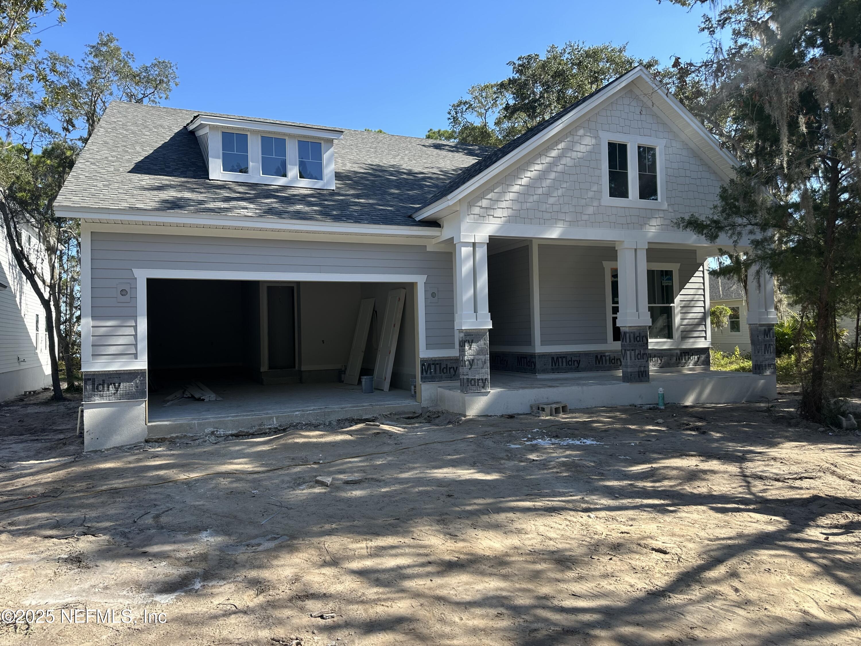 118 Historic Brick Lane St. Augustine, FL 32095 - Photo 1 of 36 a front view of a house with a yard and garage