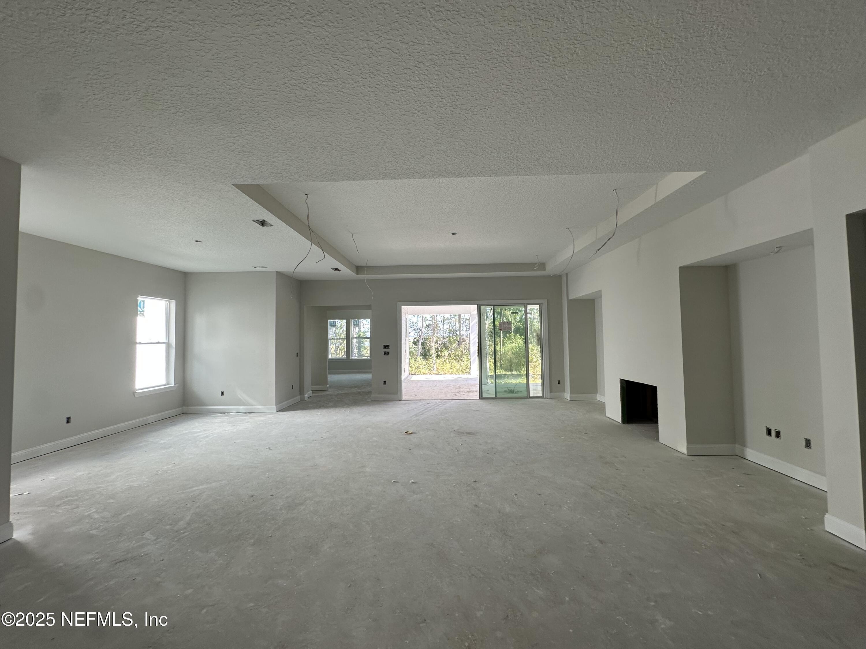 118 Historic Brick Lane St. Augustine, FL 32095 - Photo 11 of 36 a view of a big room with windows and chandelier fan