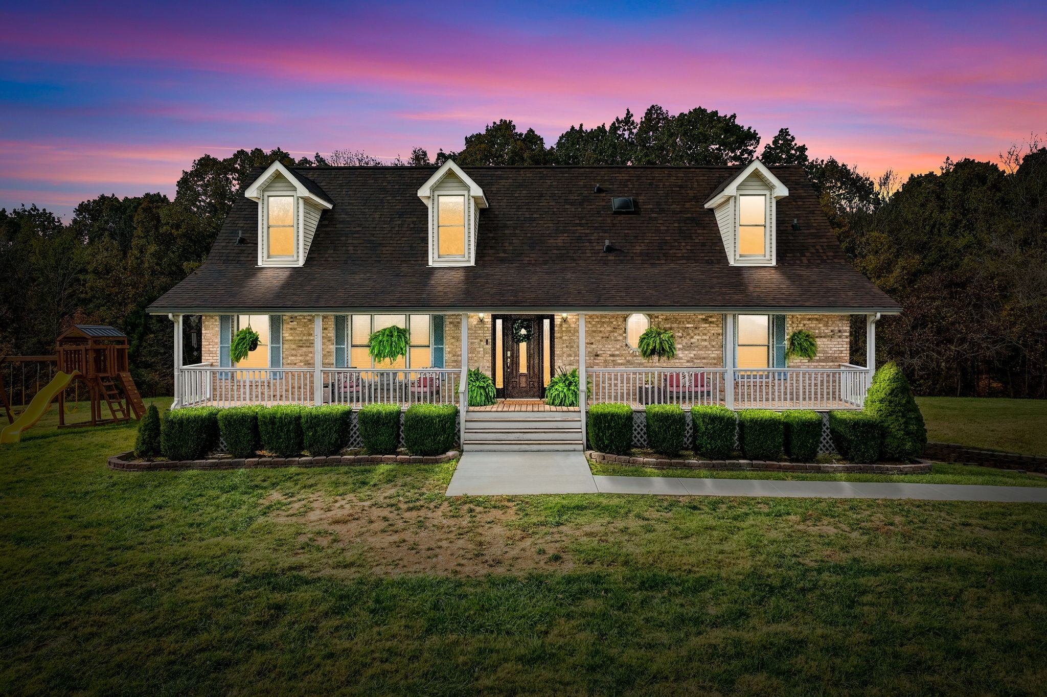a front view of a house with a yard