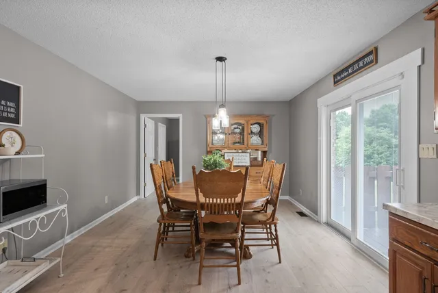 a view of a dining room with furniture window and outside view