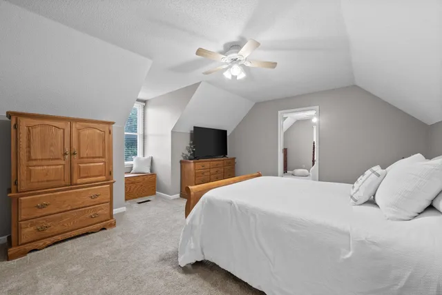 a bedroom with a large bed and furniture