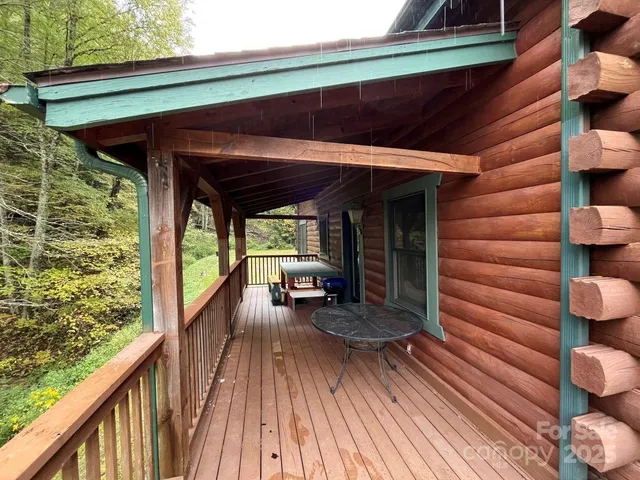 a view of a balcony with chairs and wooden floor