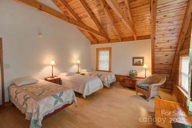 a spacious bedroom with two beds and a couch