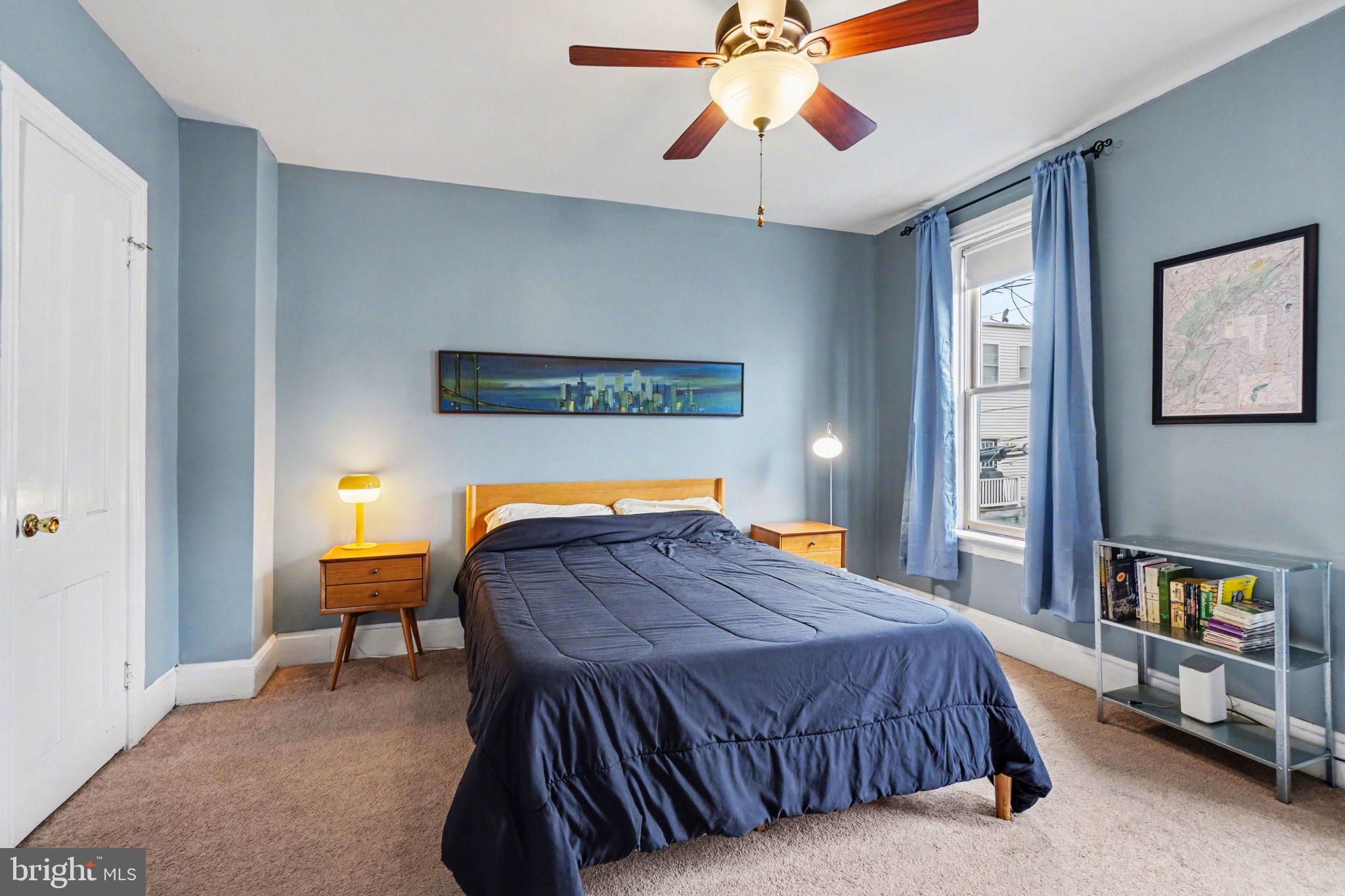 261 Delaware Street Harrisburg, PA 17102 - Photo 15 of 40 a bedroom with a bed and a chandelier