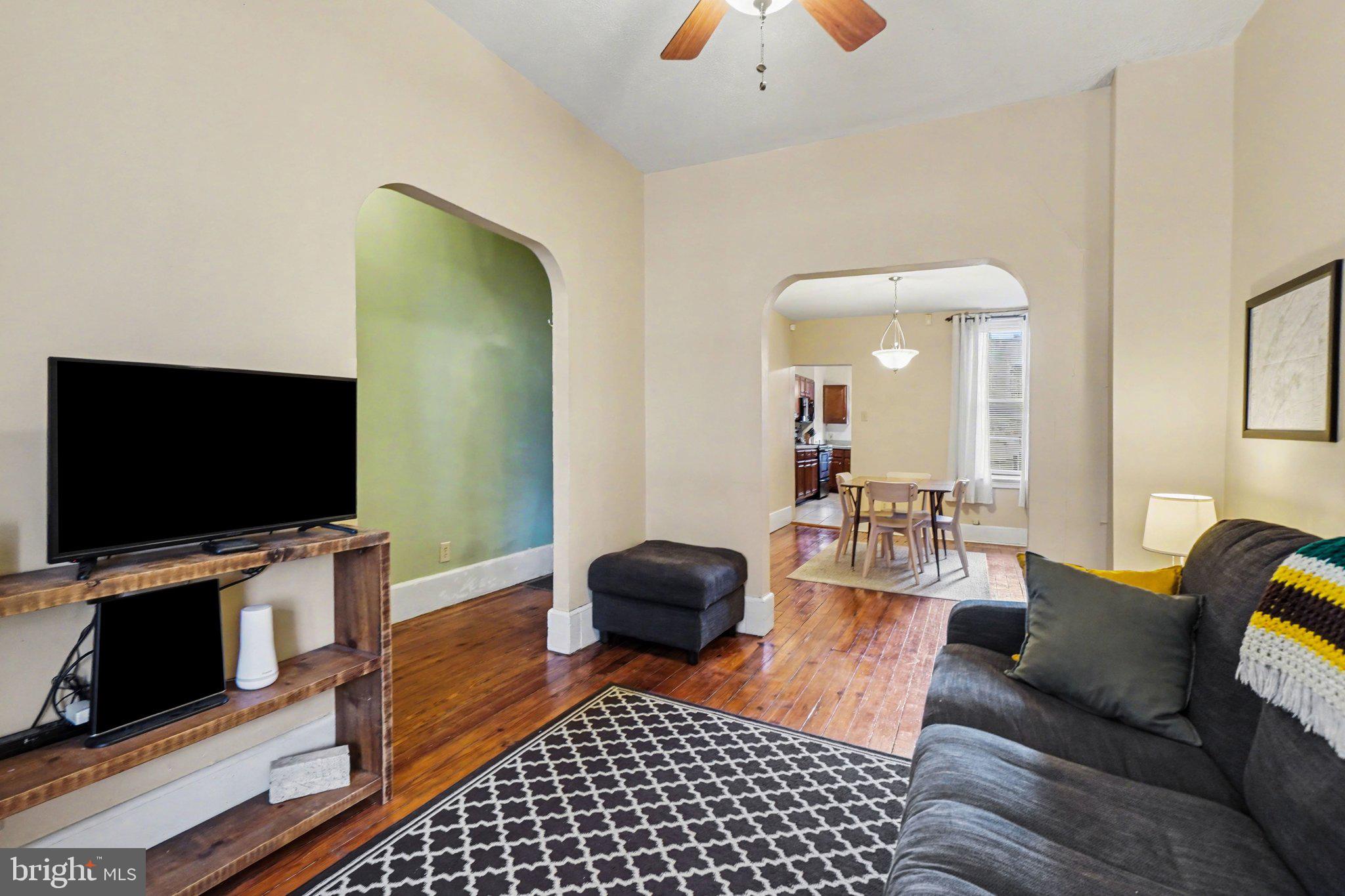 261 Delaware Street Harrisburg, PA 17102 - Photo 2 of 40 a living room with furniture and a flat screen tv