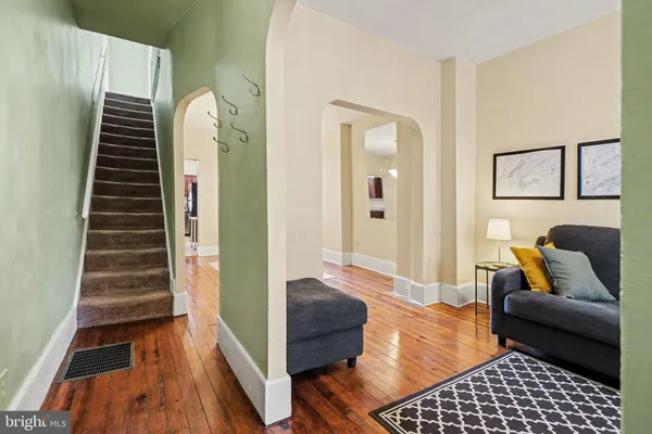 a living room with furniture and wooden floor
