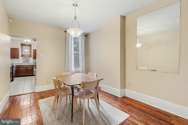 a dining room with furniture and wooden floor