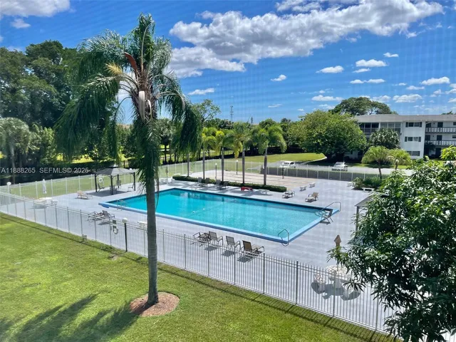 a view of a backyard with swimming pool