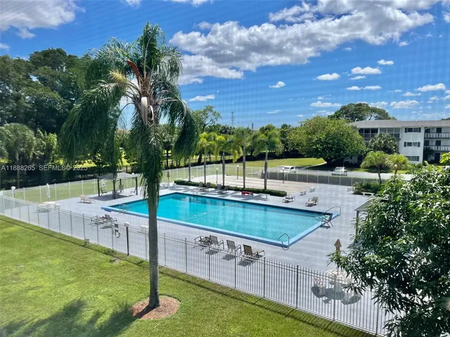 a view of a backyard with swimming pool