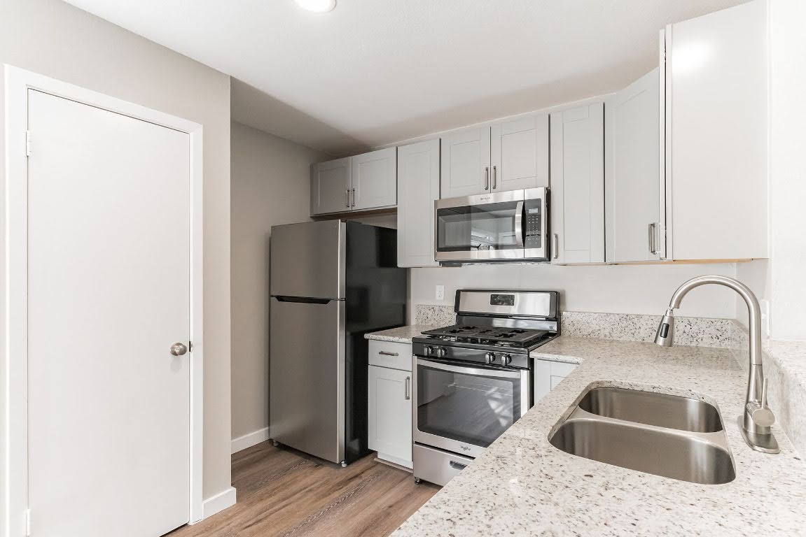 401 Hedgewood Drive, Unit D Georgetown, TX 78628 - Photo 11 of 19 a kitchen with stainless steel appliances granite countertop a refrigerator sink and stove