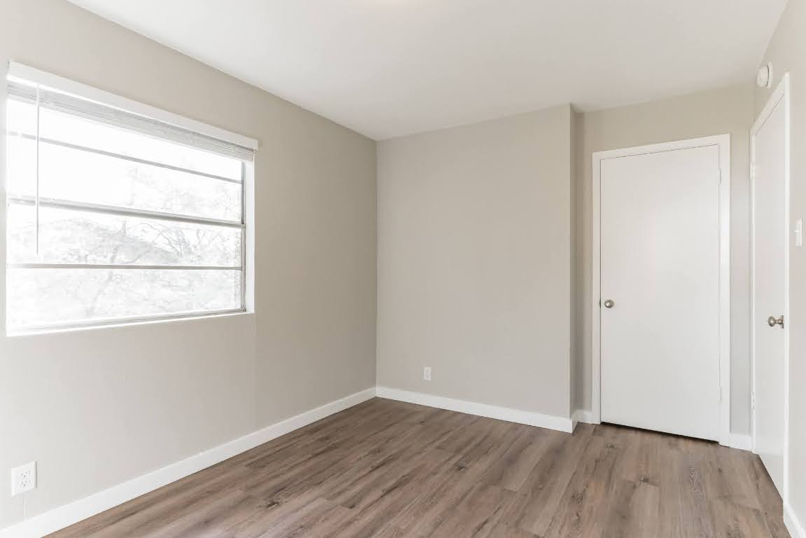 401 Hedgewood Drive, Unit D Georgetown, TX 78628 - Photo 14 of 19 a view of an empty room with wooden floor and a window