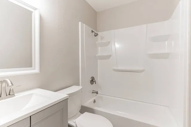 a bathroom with a sink toilet vanity and shower