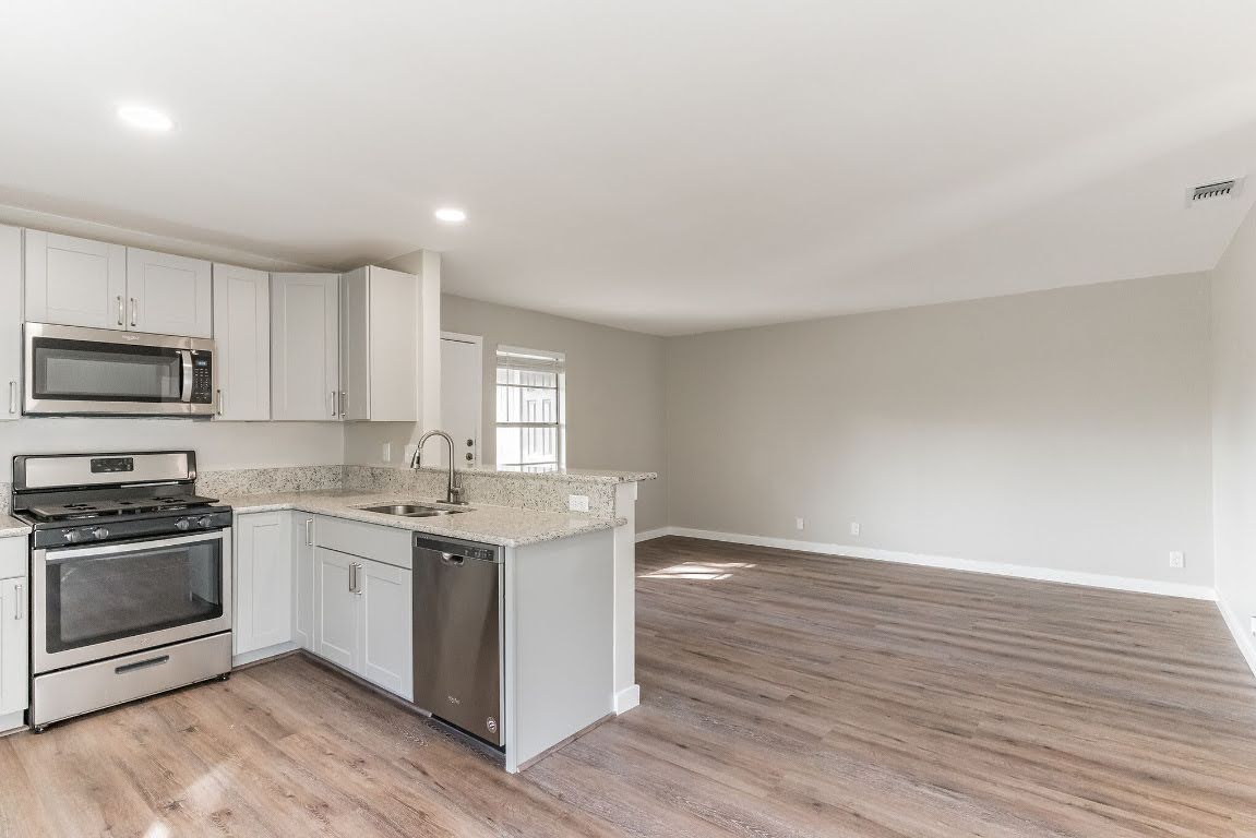 401 Hedgewood Drive, Unit D Georgetown, TX 78628 - Photo 2 of 19 a kitchen with a sink cabinets and wooden floor
