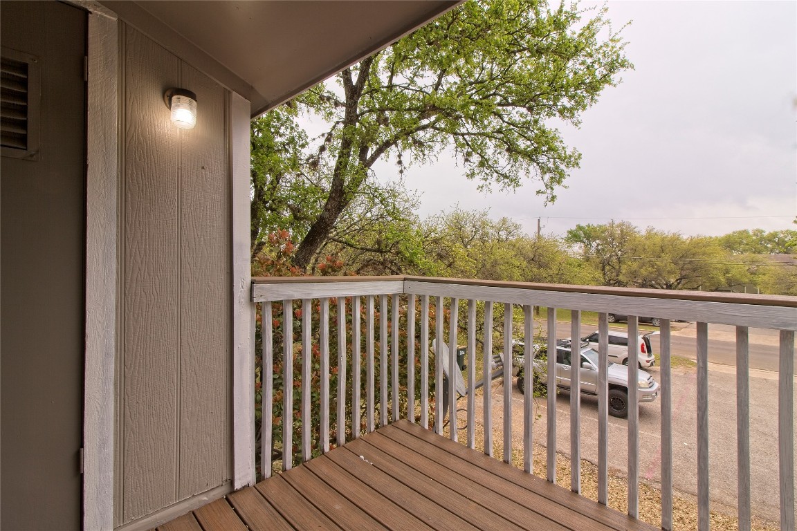 401 Hedgewood Drive, Unit D Georgetown, TX 78628 - Photo 4 of 19 a balcony with wooden floor and fence