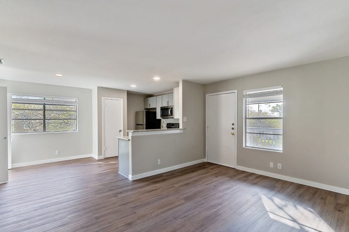 401 Hedgewood Drive, Unit D Georgetown, TX 78628 - Photo 5 of 19 wooden floor in an empty room with a window