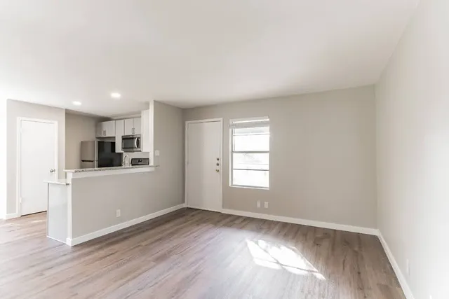 wooden floor in an empty room with a window