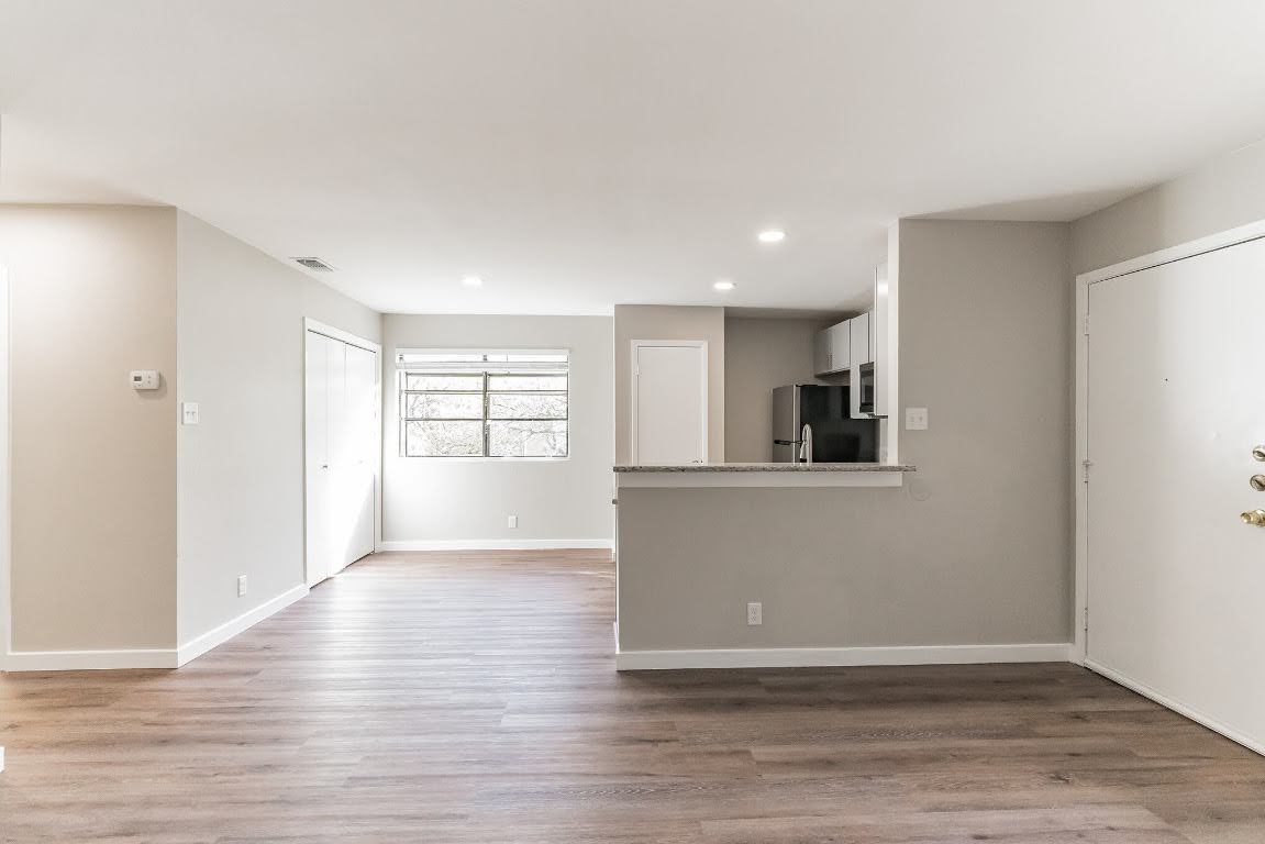 401 Hedgewood Drive, Unit D Georgetown, TX 78628 - Photo 7 of 19 a view of a kitchen with wooden floor and a window