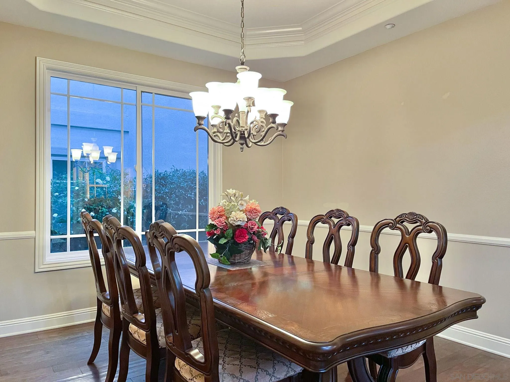 694 Cypress Hills Drive Encinitas, CA 92024 - Photo 14 of 49 a view of a dining room with furniture a chandelier and wooden floor