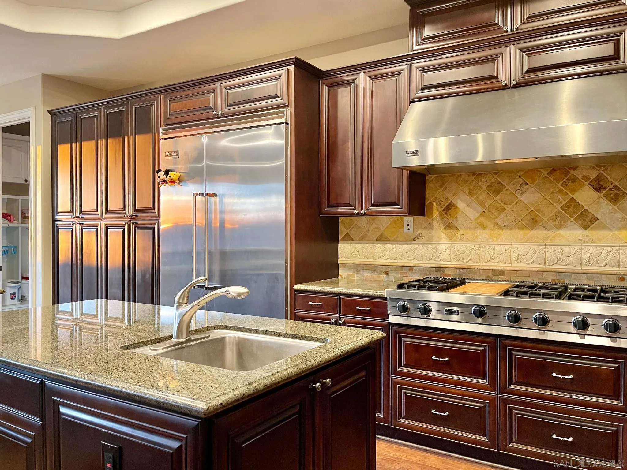 694 Cypress Hills Drive Encinitas, CA 92024 - Photo 16 of 49 a kitchen with a sink a stove and a window