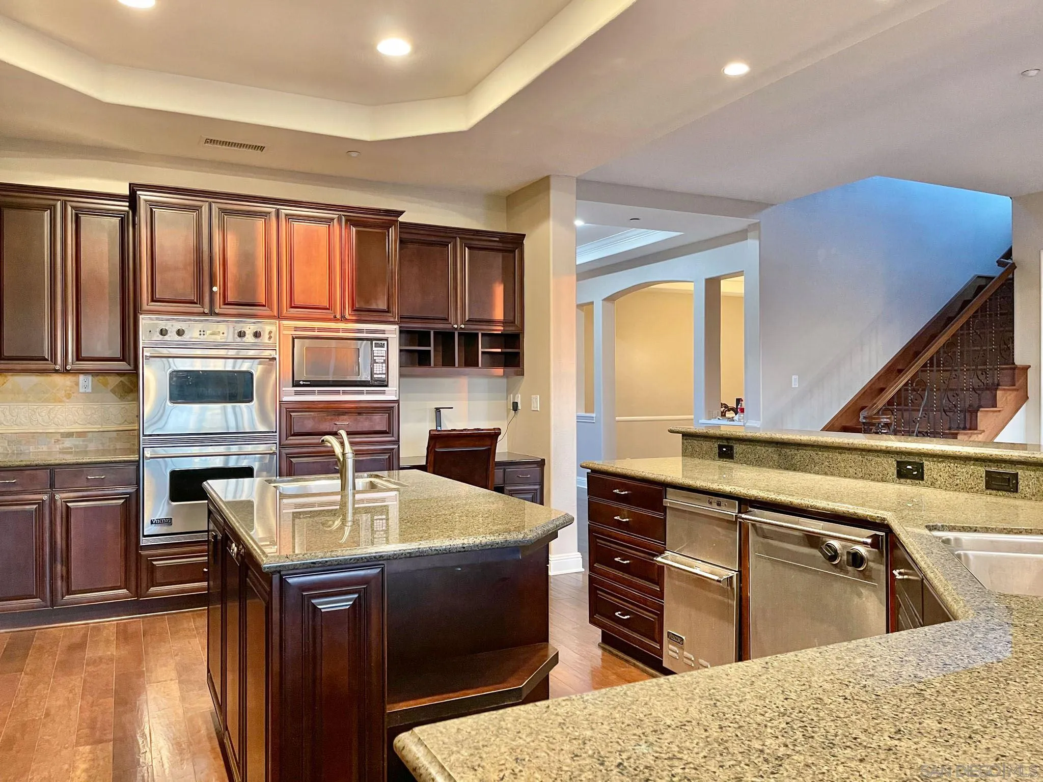 694 Cypress Hills Drive Encinitas, CA 92024 - Photo 19 of 49 a kitchen with kitchen island granite countertop a sink counter top space appliances and cabinets