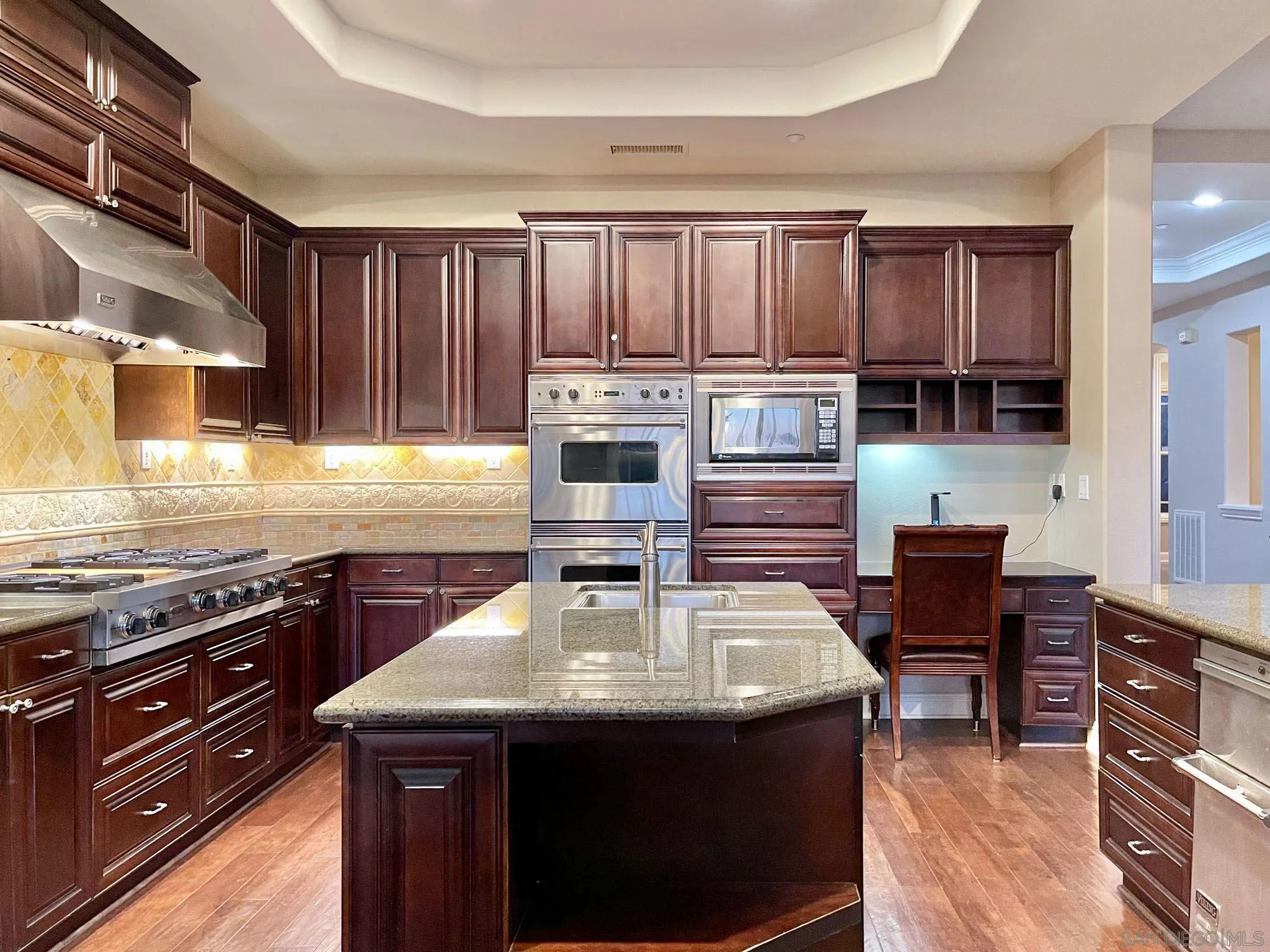 694 Cypress Hills Drive Encinitas, CA 92024 - Photo 20 of 49 a kitchen with a stove a sink and a microwave