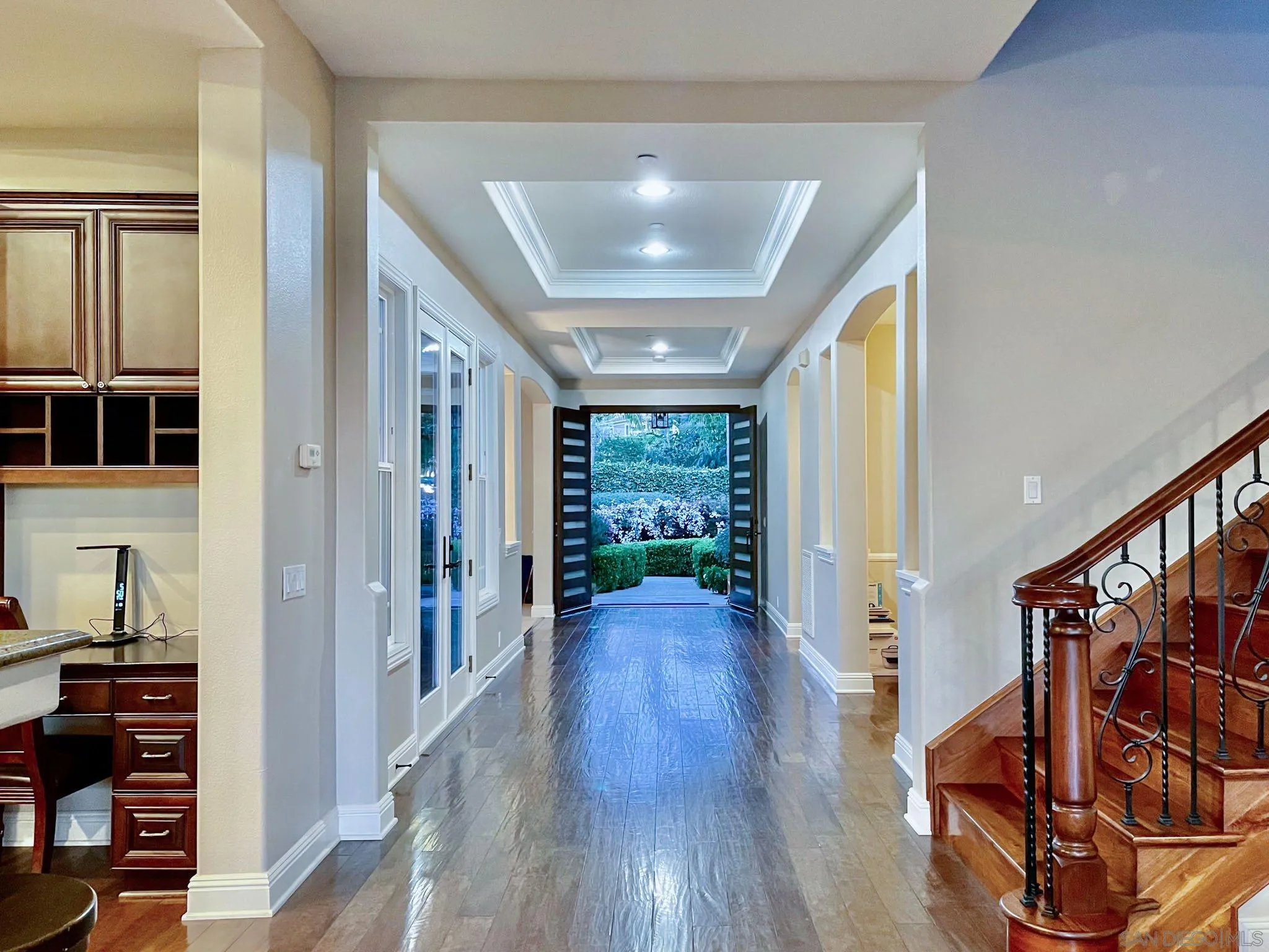 694 Cypress Hills Drive Encinitas, CA 92024 - Photo 26 of 49 a view of a hallway with wooden floor windows and a livingroom
