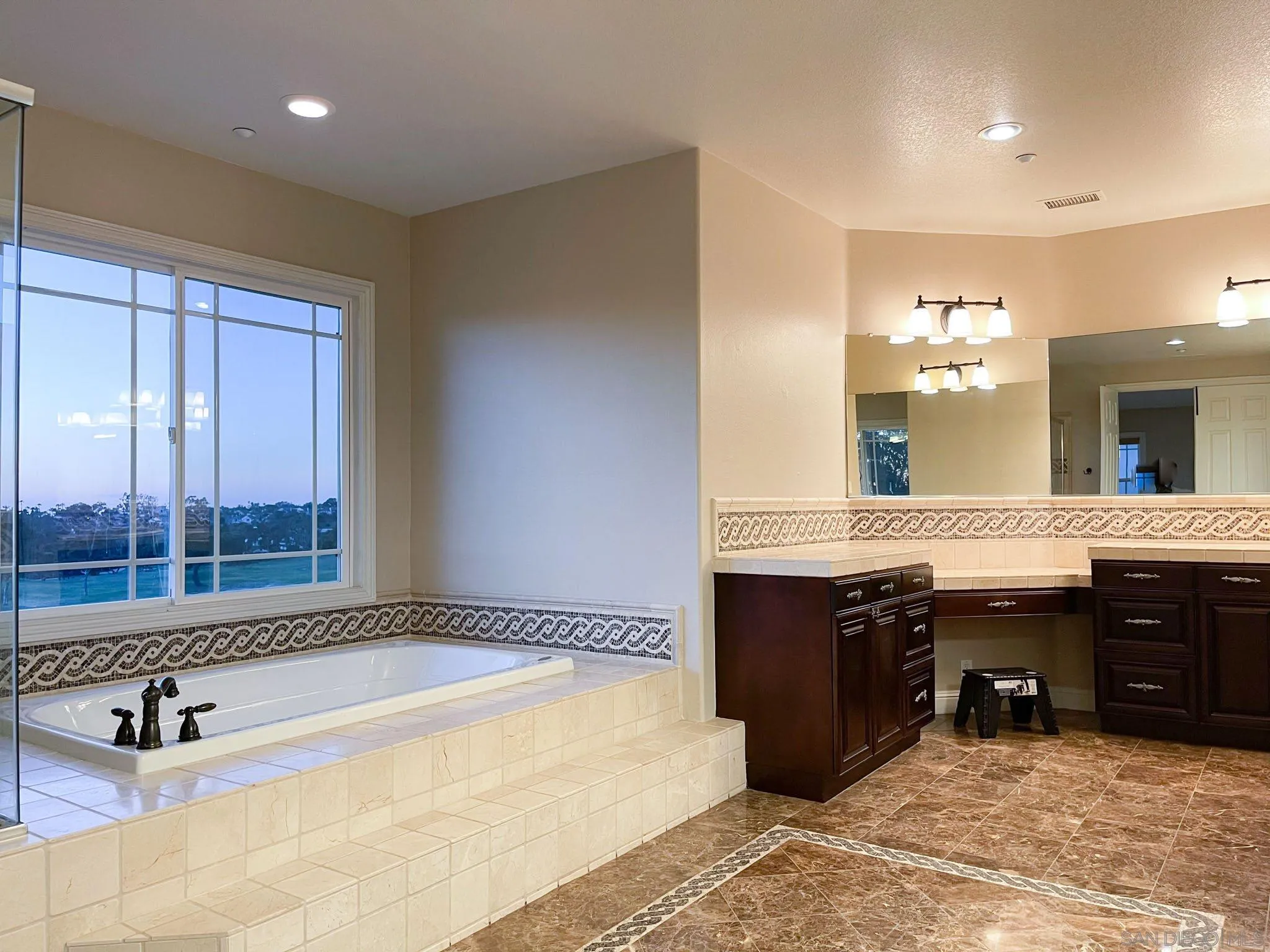 694 Cypress Hills Drive Encinitas, CA 92024 - Photo 32 of 49 a spacious bathroom with a tub a sink and mirror
