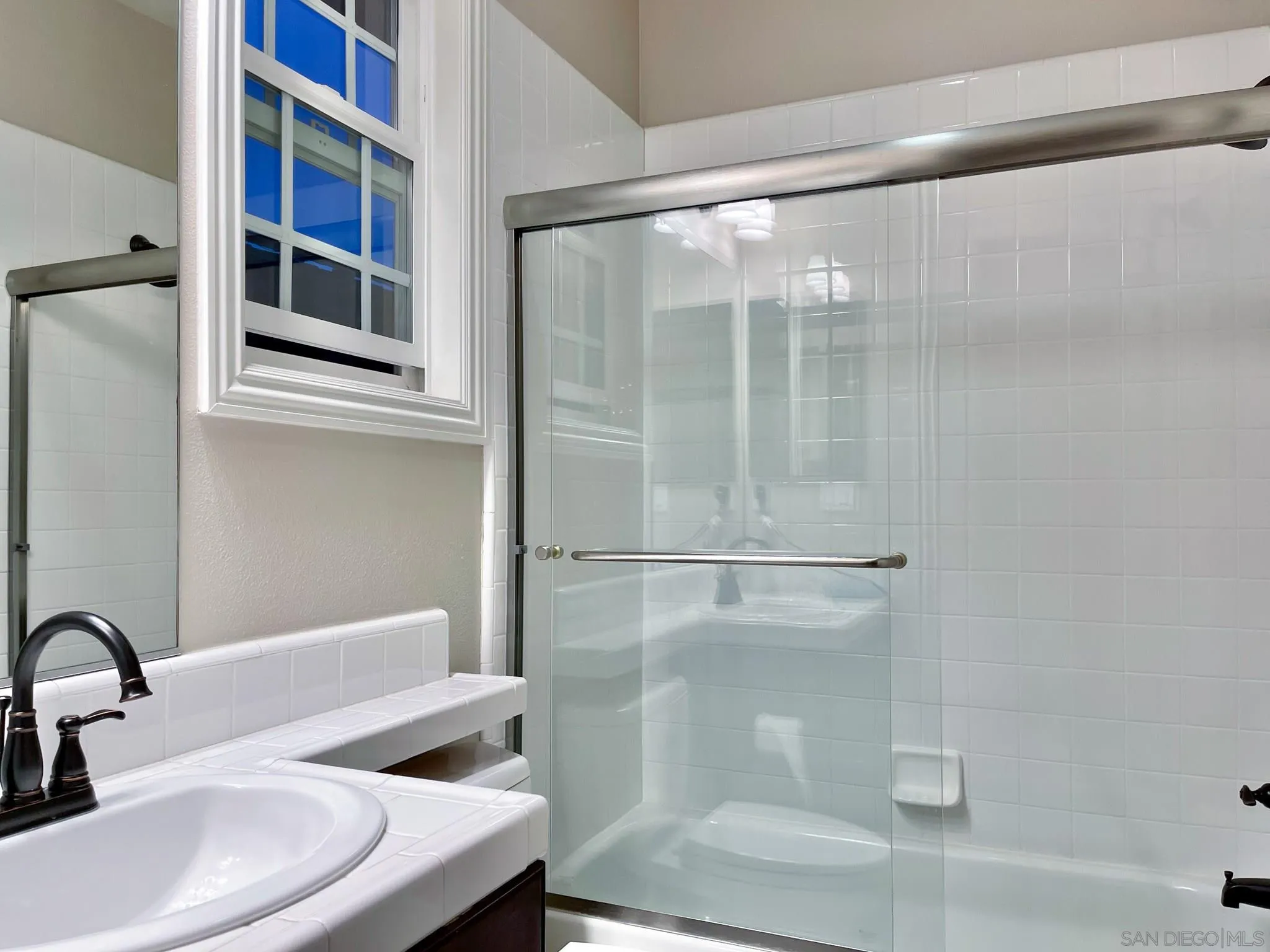 694 Cypress Hills Drive Encinitas, CA 92024 - Photo 39 of 49 a bathroom with a sink and mirror