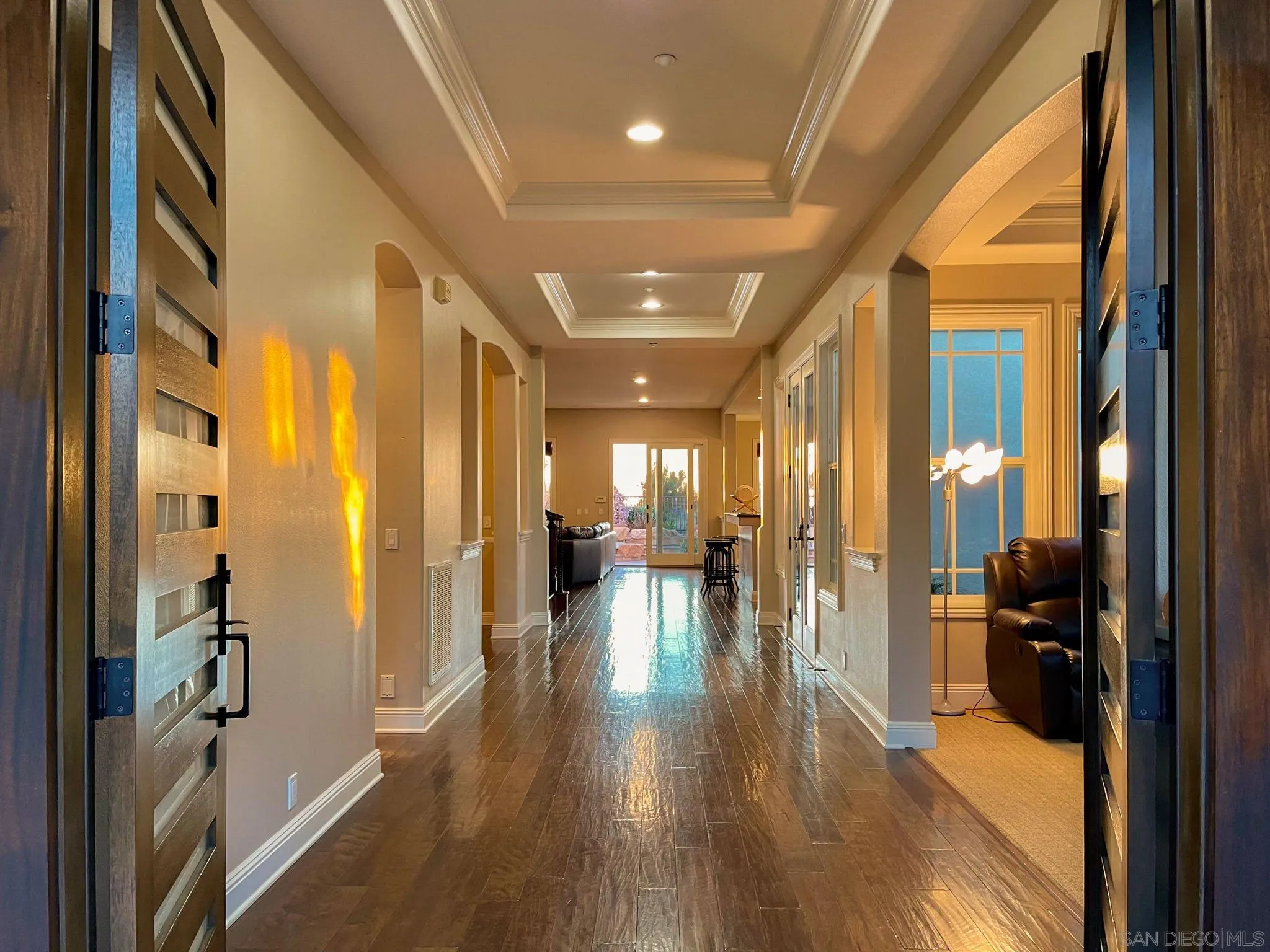 694 Cypress Hills Drive Encinitas, CA 92024 - Photo 8 of 49 a view of a hallway with wooden floor and furniture