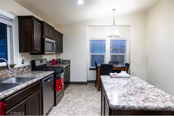 a bathroom with a granite countertop bathtub shower sink and toilet