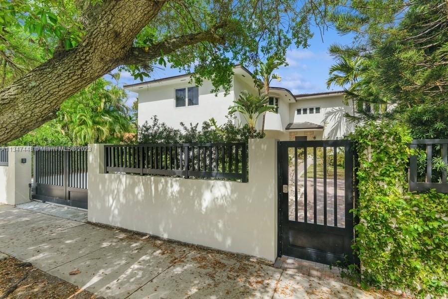 543 Southwest 29th Road Miami, FL 33129 - Photo 7 of 44 a front view of a house with a yard and tree s