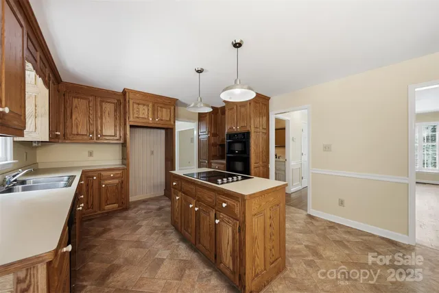 a kitchen with stainless steel appliances granite countertop a stove and a sink
