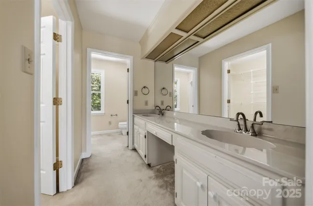 a bathroom with a double vanity sink and mirror