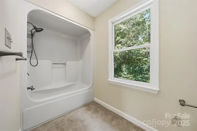 a bathroom with a bath tub with a shower