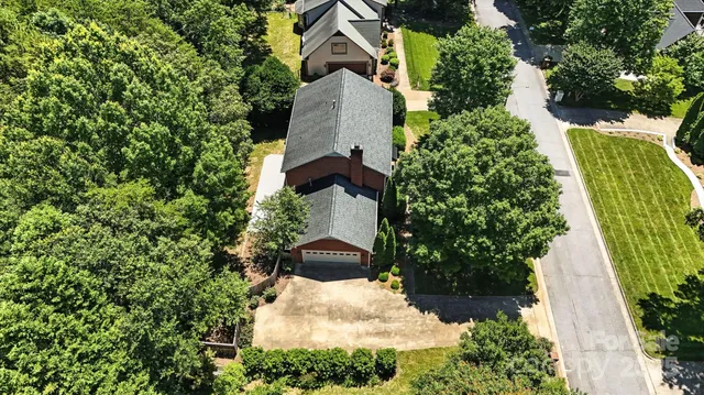 an aerial view of a house with a yard and garden