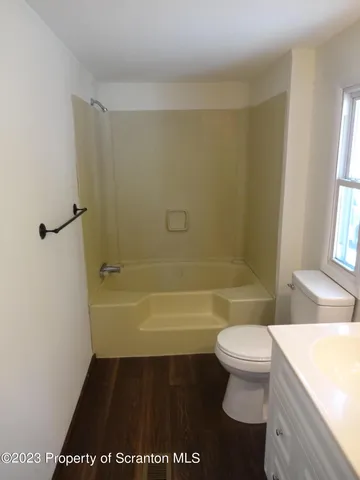 a bathroom with a bathtub and a toilet
