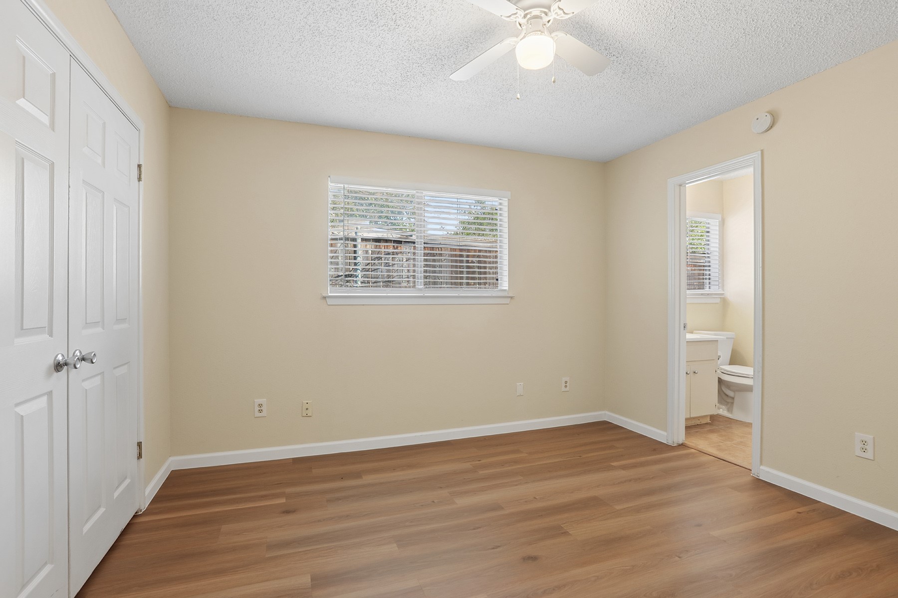 3114 Plantation Road, Unit A Austin, TX 78745 - Photo 9 of 15 A private, naturally lit space features durable wood flooring and a refreshing ceiling fan.