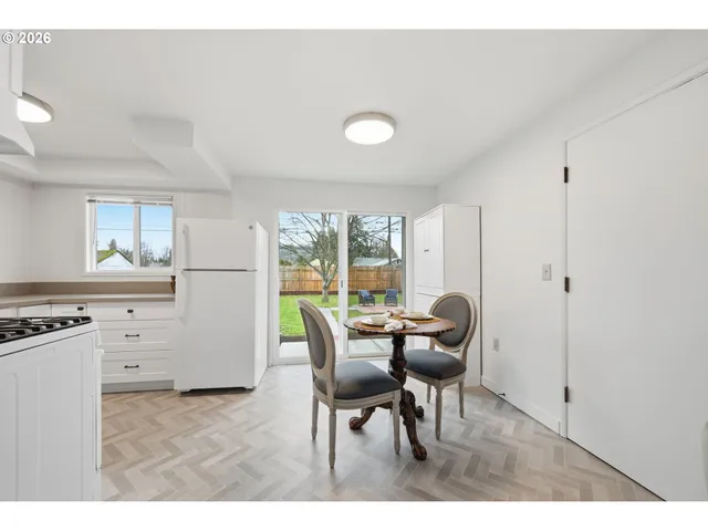 a dining room with furniture and window