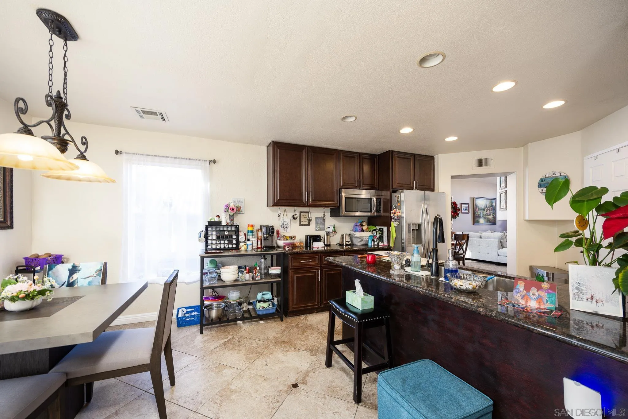 5063 Frazee Road Oceanside, CA 92057 - Photo 11 of 45 a room with stainless steel appliances kitchen island granite countertop furniture and a dining table