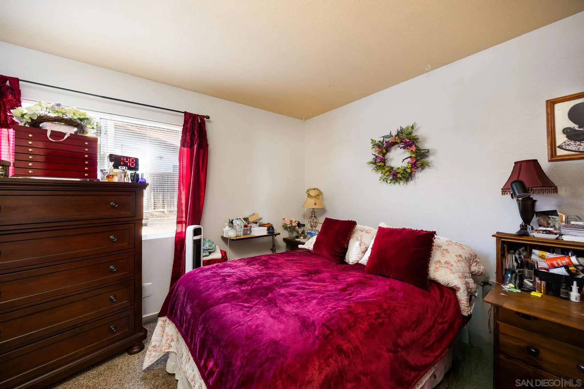 5063 Frazee Road Oceanside, CA 92057 - Photo 16 of 45 a bed room with a bed and a night stand