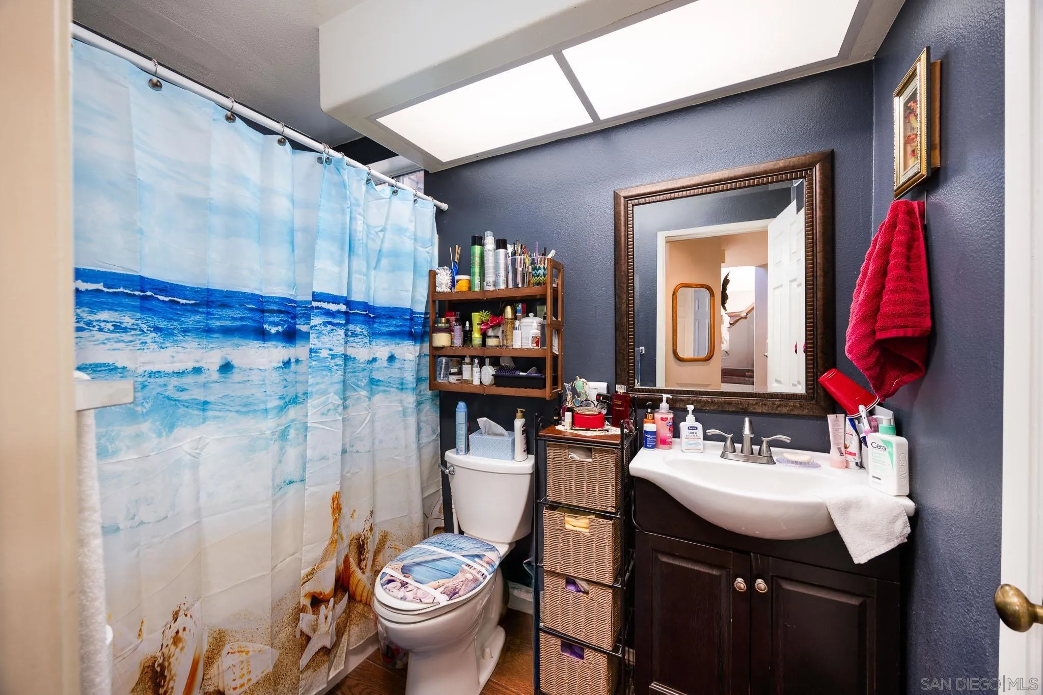 5063 Frazee Road Oceanside, CA 92057 - Photo 18 of 45 a bathroom with a sink vanity mirror and toilet