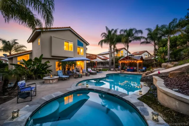 a front view of a house with swimming pool and a yard