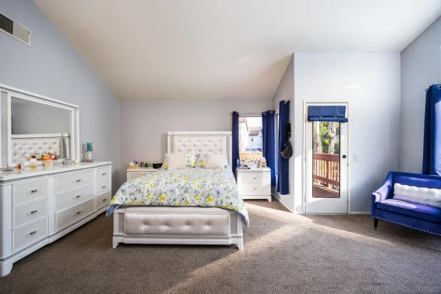 a bedroom with a bed and a window