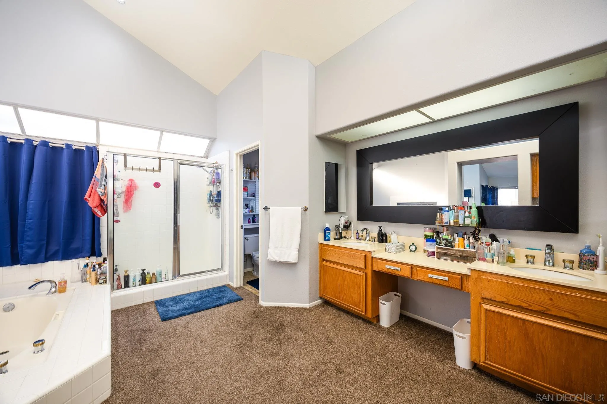 5063 Frazee Road Oceanside, CA 92057 - Photo 27 of 45 a bathroom with a tub sink and mirror