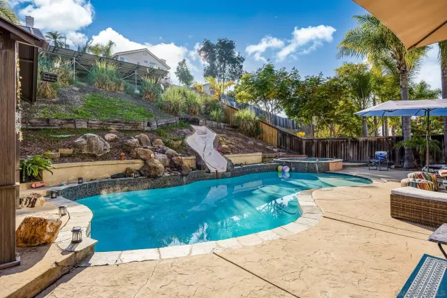 a view of a backyard with sitting area