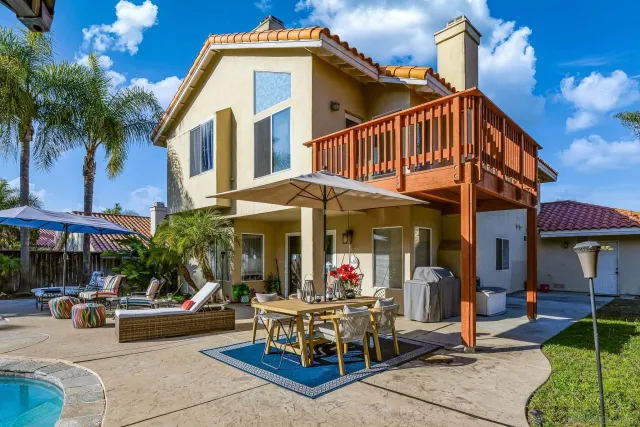 a view of a patio with a table and chairs under an umbrella